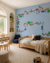 Playful cars and city roads kids room wallpaper in a toddler bedroom with a child-sized bed.