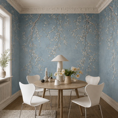 Blue cherry blossom wallpaper in a dining room with round table.
