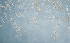 Dusty blue textured wallpaper with white cherry blossom branches hanging from the top.