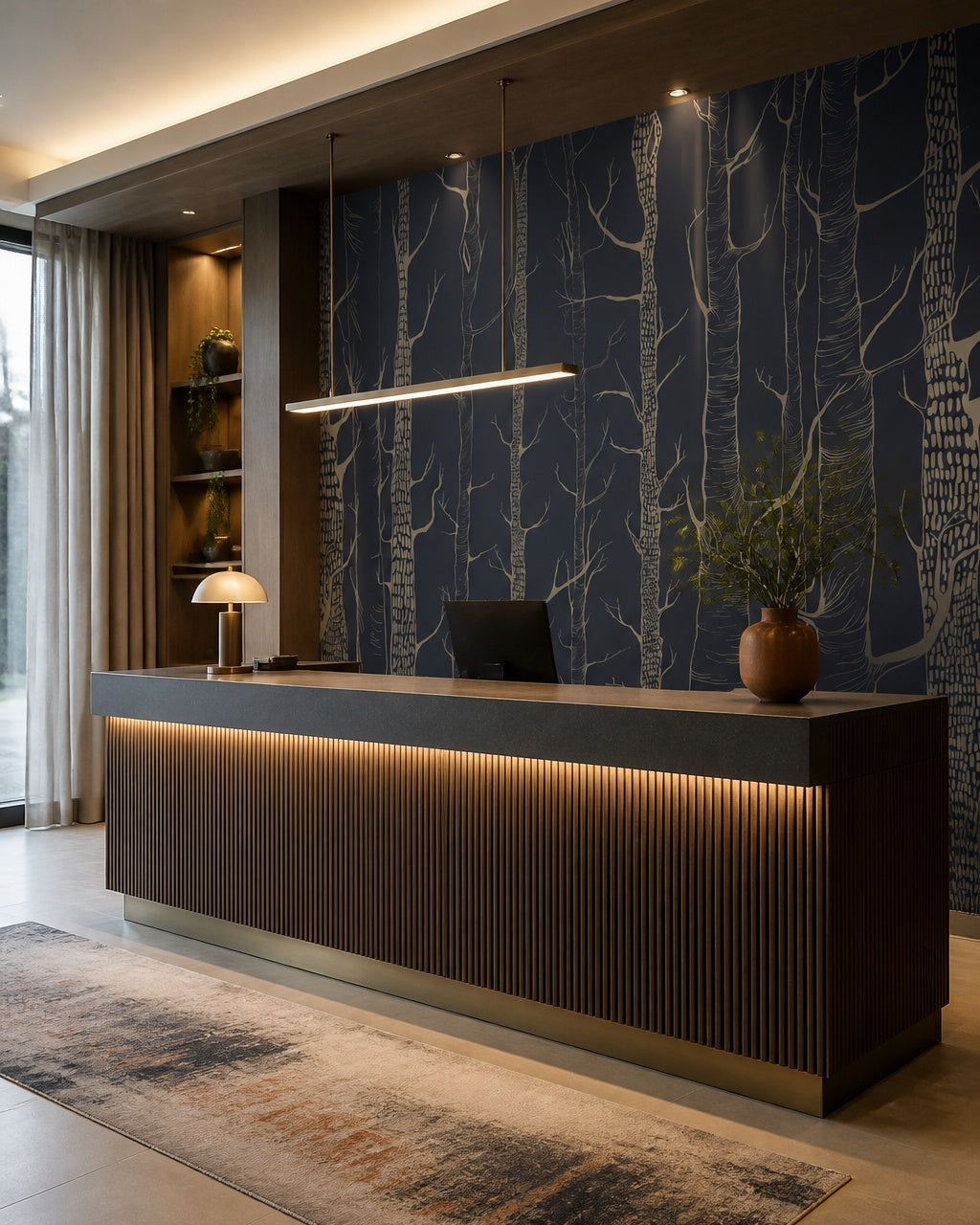 Golden trees on navy wallpaper at a hotel reception desk.
