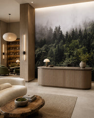 Misty pine forest wallpaper in a boutique hotel lobby.