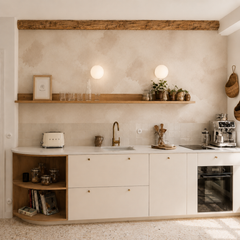 Abstract beige watercolor wallpaper displayed in a modern neutral kitchen with white cabinets and natural wood details.