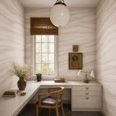 Soft beige marble wallpaper shown in a refined home office with built-in desk, wood chair and brass details.