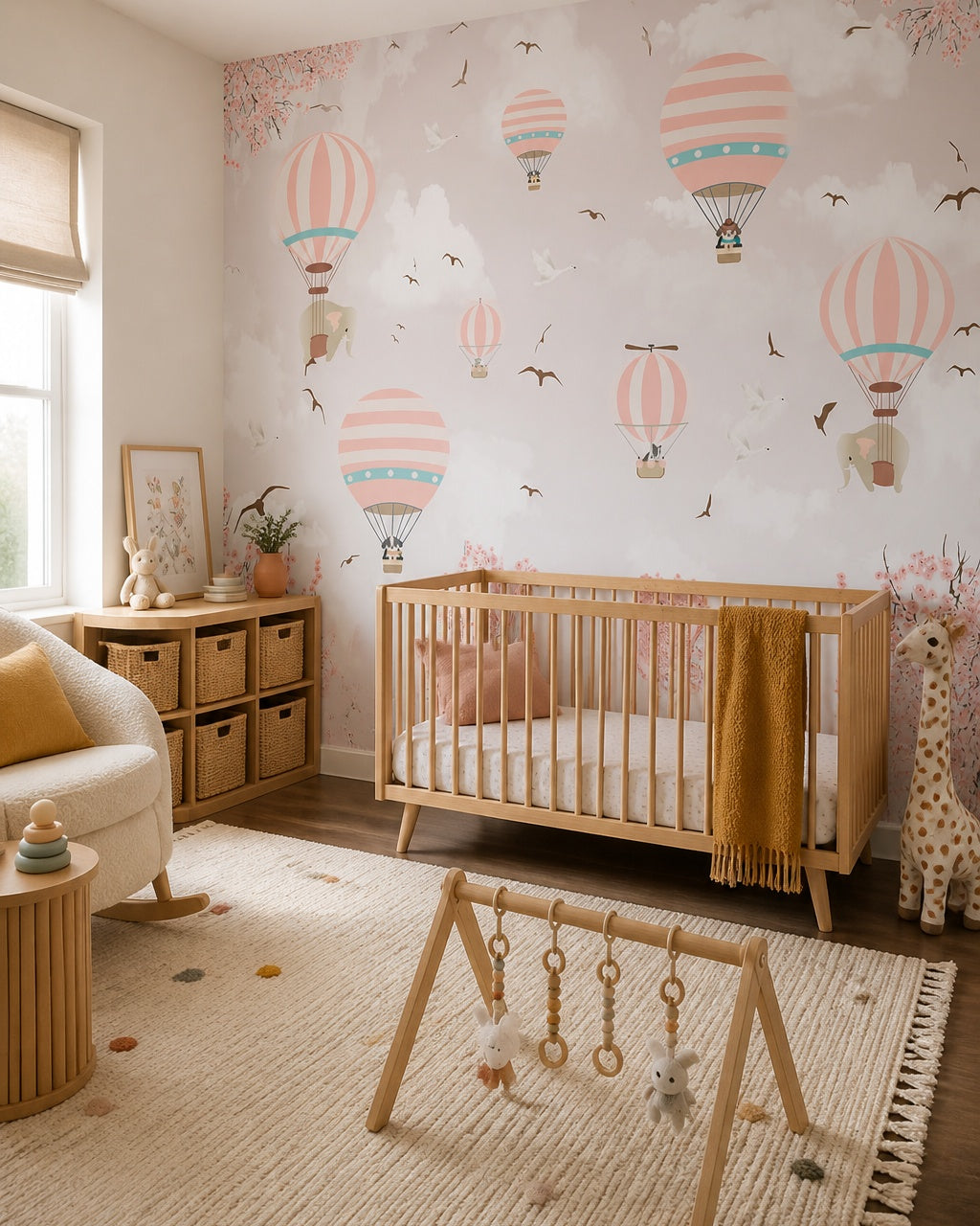 Pink sky hot air balloons wallpaper in a modern nursery with a crib.