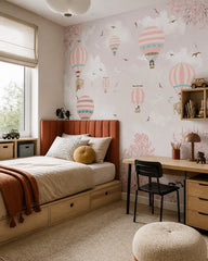 Pink sky hot air balloons wallpaper in a boy’s bedroom.