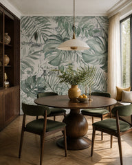 Monstera leaves wallpaper in a refined dining area.