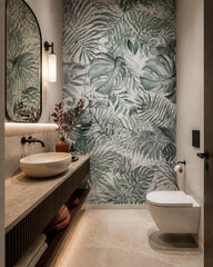 Monstera leaves wallpaper in an elegant powder room.