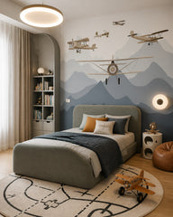 Vintage airplanes over the mountains kids room wallpaper in a boy’s bedroom.