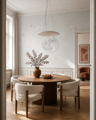 Soft moon and stars wallpaper in a refined dining area.