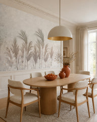 Pastel pampas grass wallpaper in a refined dining area.