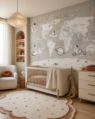 Astronaut adventure world map kids’ wall mural in a modern nursery with a crib.