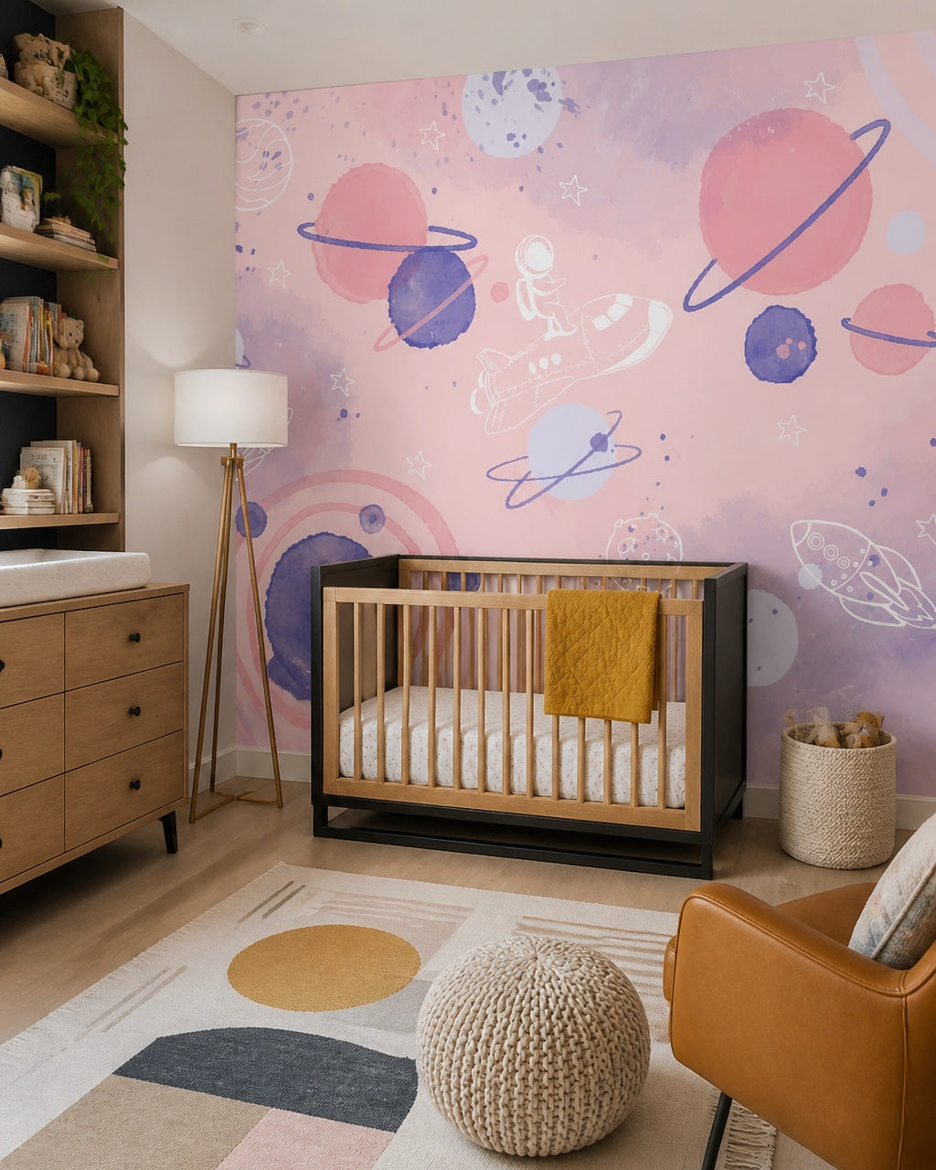 Dreamy pink space adventure nursery wallpaper in a modern nursery with a crib.