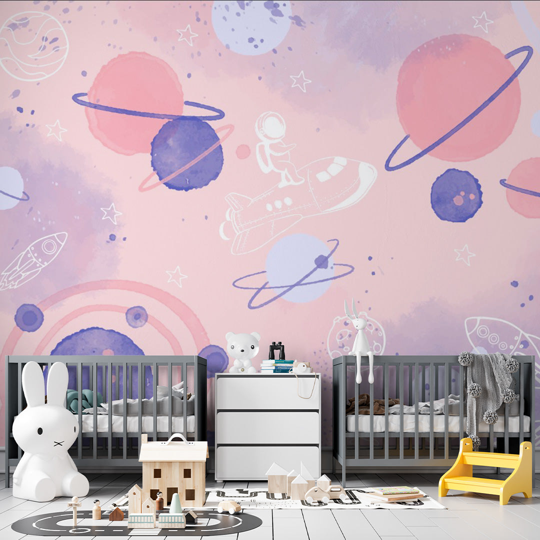 Pink watercolor nursery wallpaper with colorful planets, rings, rockets, stars, moons, and an astronaut riding a spaceship.