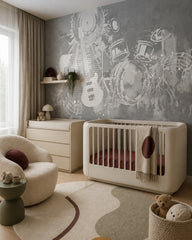 Grey guitar and drums wallpaper in a nursery with a cream crib and a round armchair.