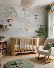 Rose garden hot air balloons wallpaper in a modern nursery with a crib.
