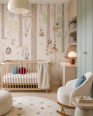 Pastel woodland wallpaper in a modern nursery with a crib.