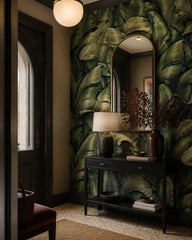 Dark green banana leaves wallpaper in a designer entrance hall.