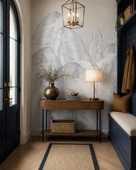 Pale blue banana leaves wallpaper in a refined foyer.