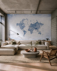 Blue watercolor world map wallpaper in a designer living room.