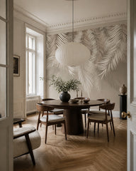 Silver palm leaf wallpaper in a refined dining area.