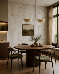 Grey line art leaves wallpaper in a refined dining area.