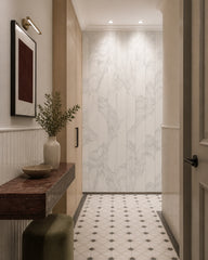 Grey line art leaves wallpaper in an architectural hallway.