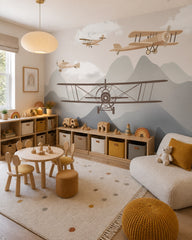 Vintage airplanes over the mountains kids room wallpaper in a children’s playroom.