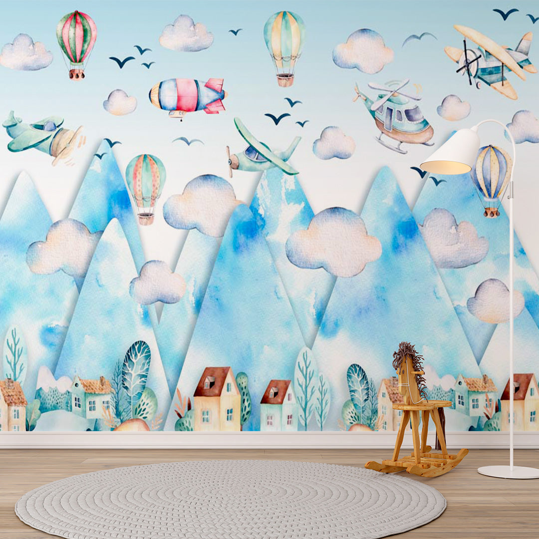 Watercolor kids room wallpaper with airplanes, balloons, a helicopter, and an airship flying above blue mountains and a village.