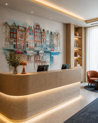 Amsterdam canal houses wallpaper at a hotel reception desk.