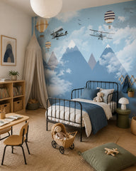 Vintage flights above misty mountains wallpaper in a girl’s bedroom.