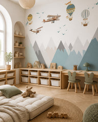 Vintage airplanes and balloons over mountains wallpaper in a children’s playroom.