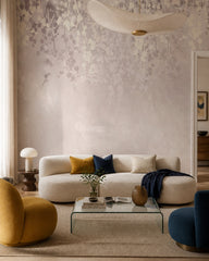 Neutral blush leaves wallpaper in a designer living room.