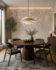 Neutral blush leaves wallpaper in a refined dining area.