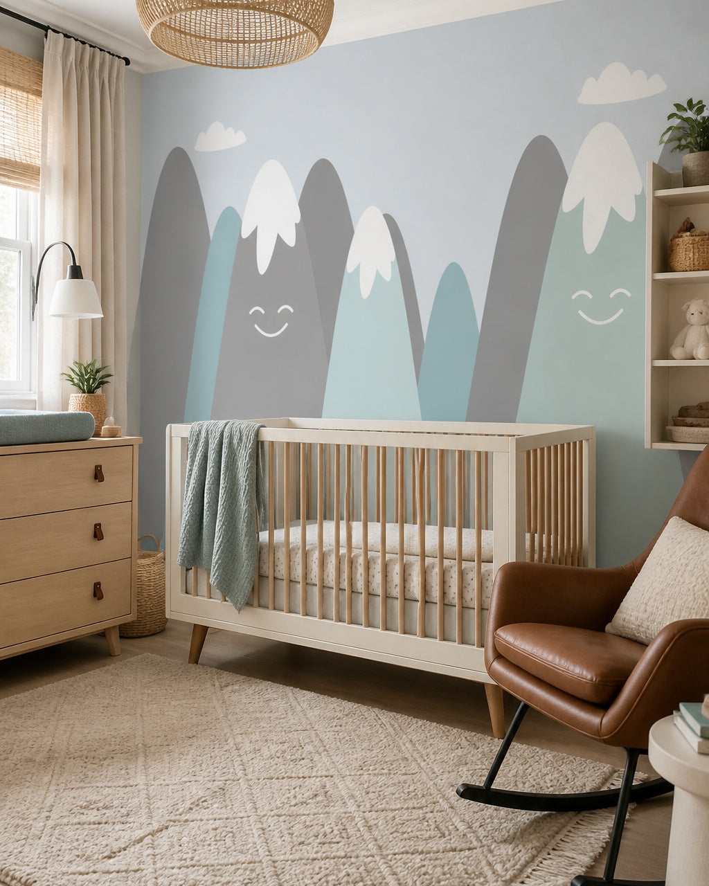 Happy snowy mountains kids room wallpaper in a modern nursery with a crib.