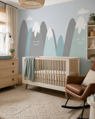 Happy snowy mountains kids room wallpaper in a modern nursery with a crib.