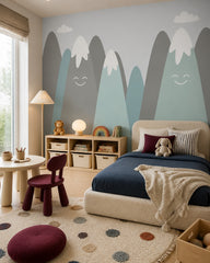 Happy snowy mountains kids room wallpaper in a toddler bedroom with a child-sized bed.