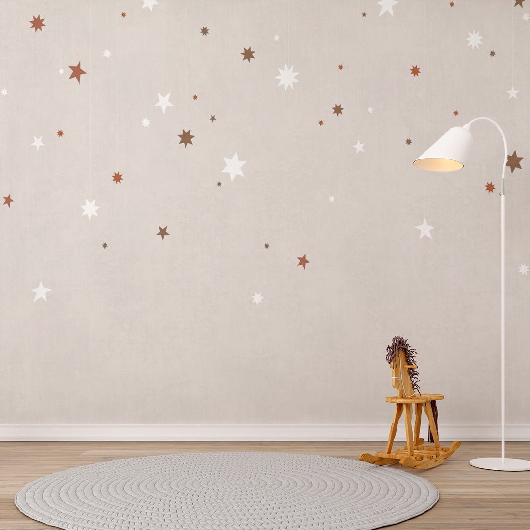Neutral beige nursery wallpaper with hanging white, brown and terracotta stars