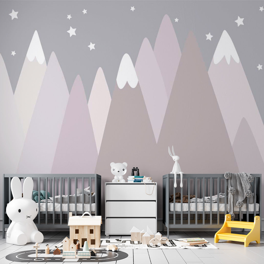 Pastel nursery wallpaper with layered blush, lavender, taupe, and cream mountains, white snowcaps, and scattered stars.