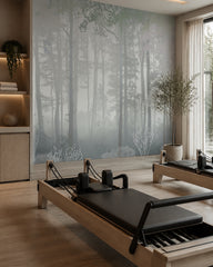 Blue grey misty forest wallpaper in a fitness studio.