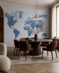 Blue world map wallpaper in a refined dining area.