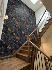 Navy wildflower wallpaper on a staircase wall.