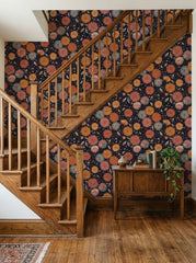 Dark dahlia wallpaper on a staircase wall.