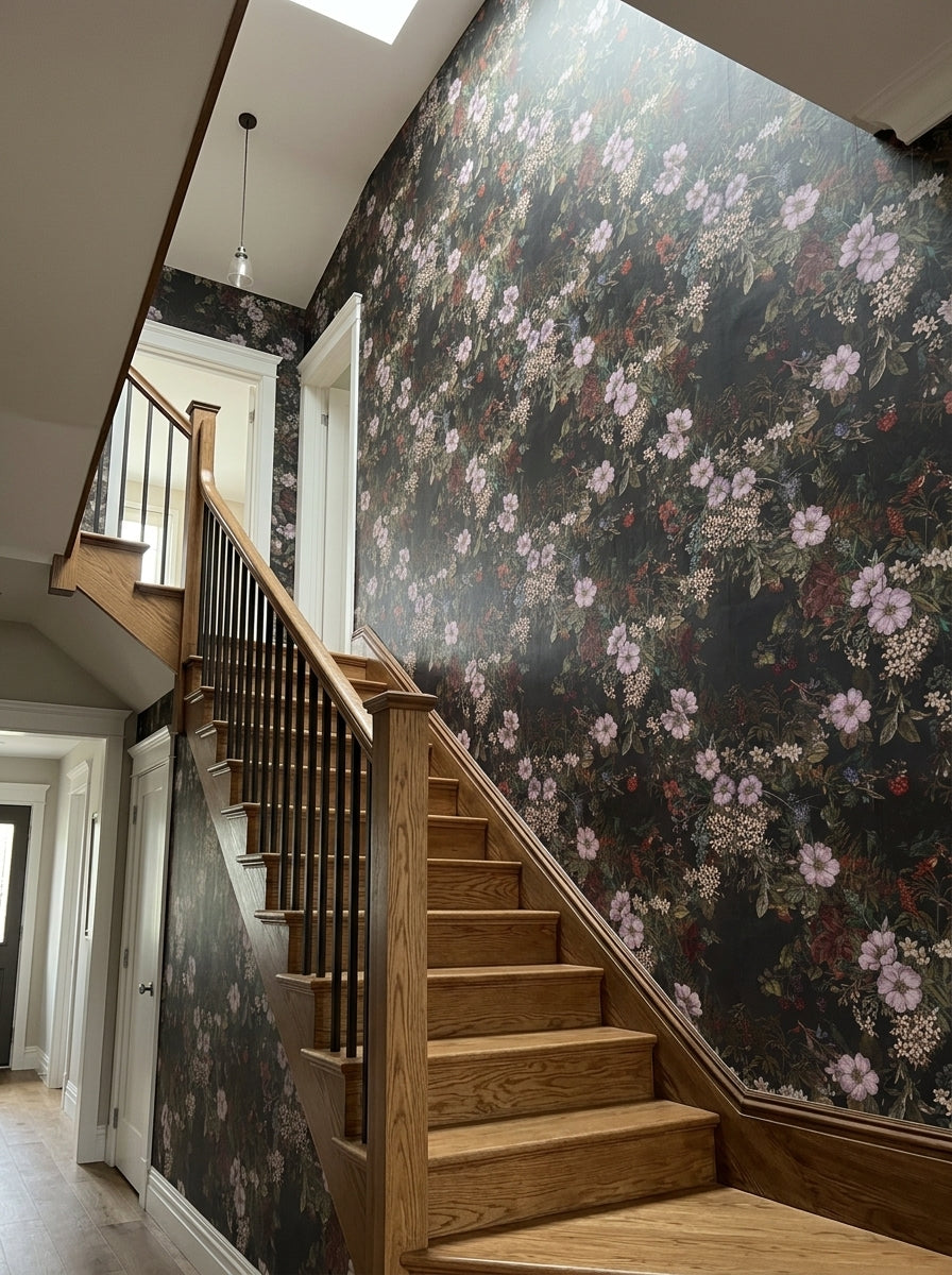 Dark floral wallpaper with lilac blossoms on a staircase wall.