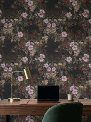 Dark floral wallpaper with lilac blossoms in a home office.