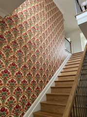 Red peony arch wallpaper on a staircase wall.