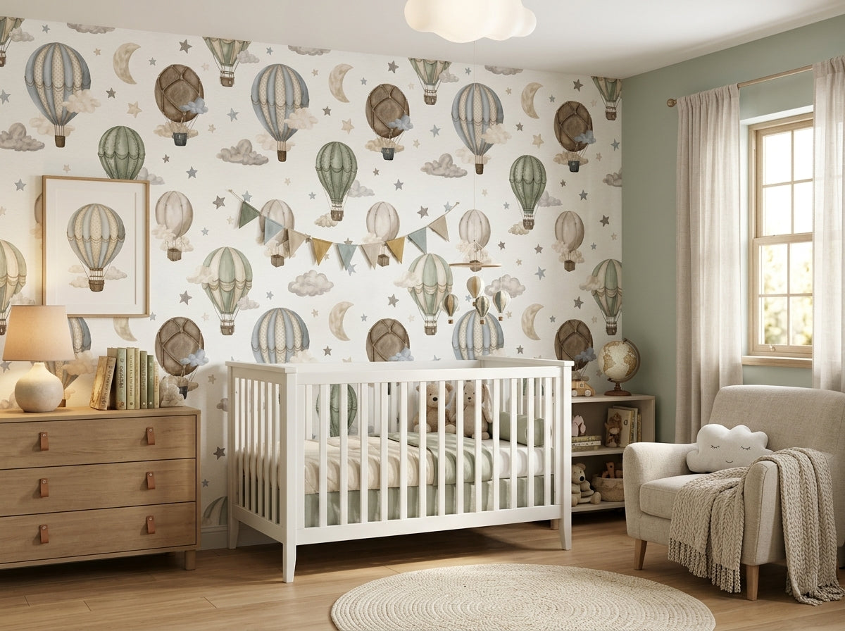 Watercolor hot air balloon wall mural shown in a soft neutral baby room with white crib and cozy armchair.