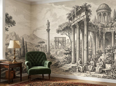 Grey Roman ruins wallpaper behind a green velvet armchair.