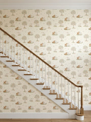 Lambs and apple trees wallpaper on a staircase wall.