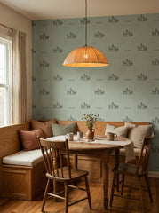 Sage green goats wallpaper in a breakfast nook.