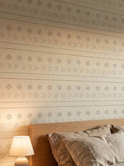 Boho stitch wallpaper in a bedroom.